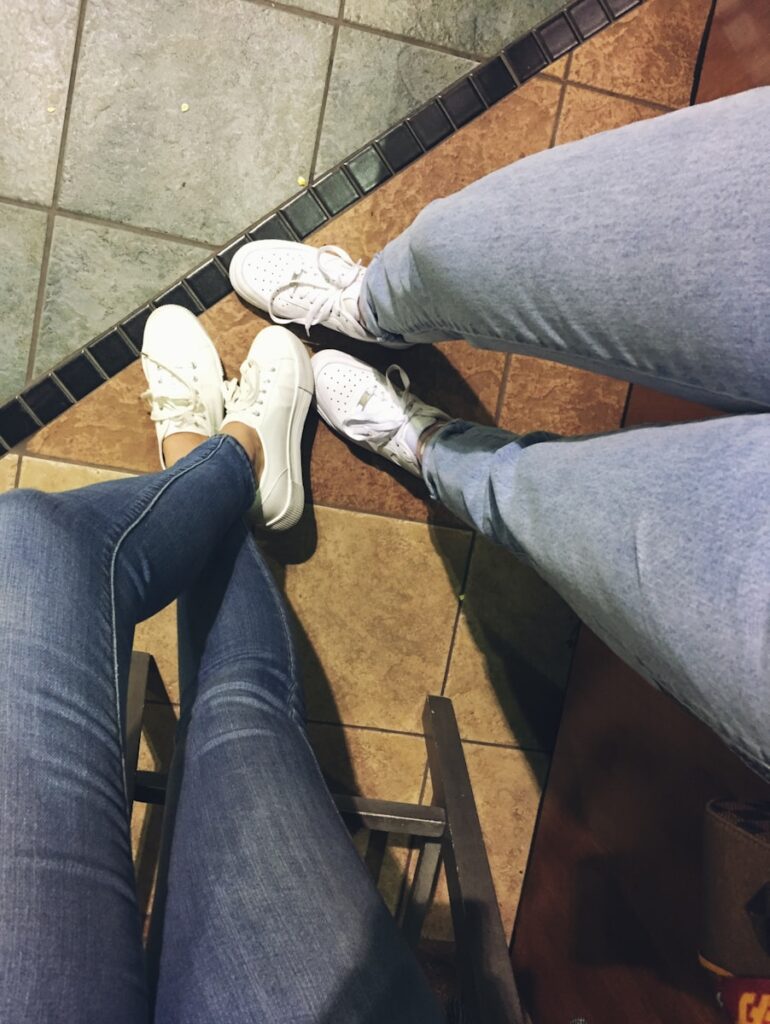 women wears white low-top sneakers